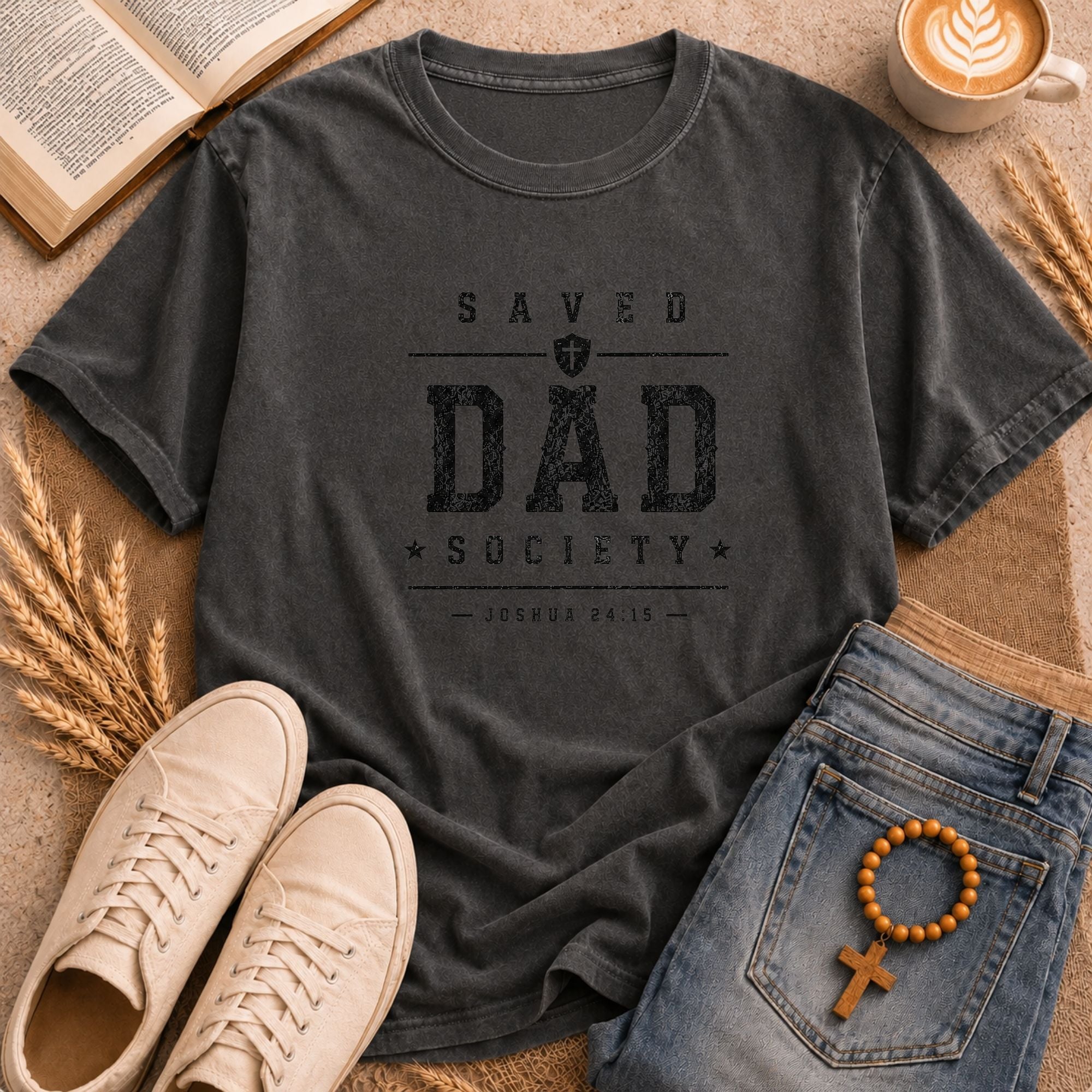 Men's Christian apparel — Saved Dad Society graphic tee in olive with distressed varsity font, cross shield, and scripture reference 